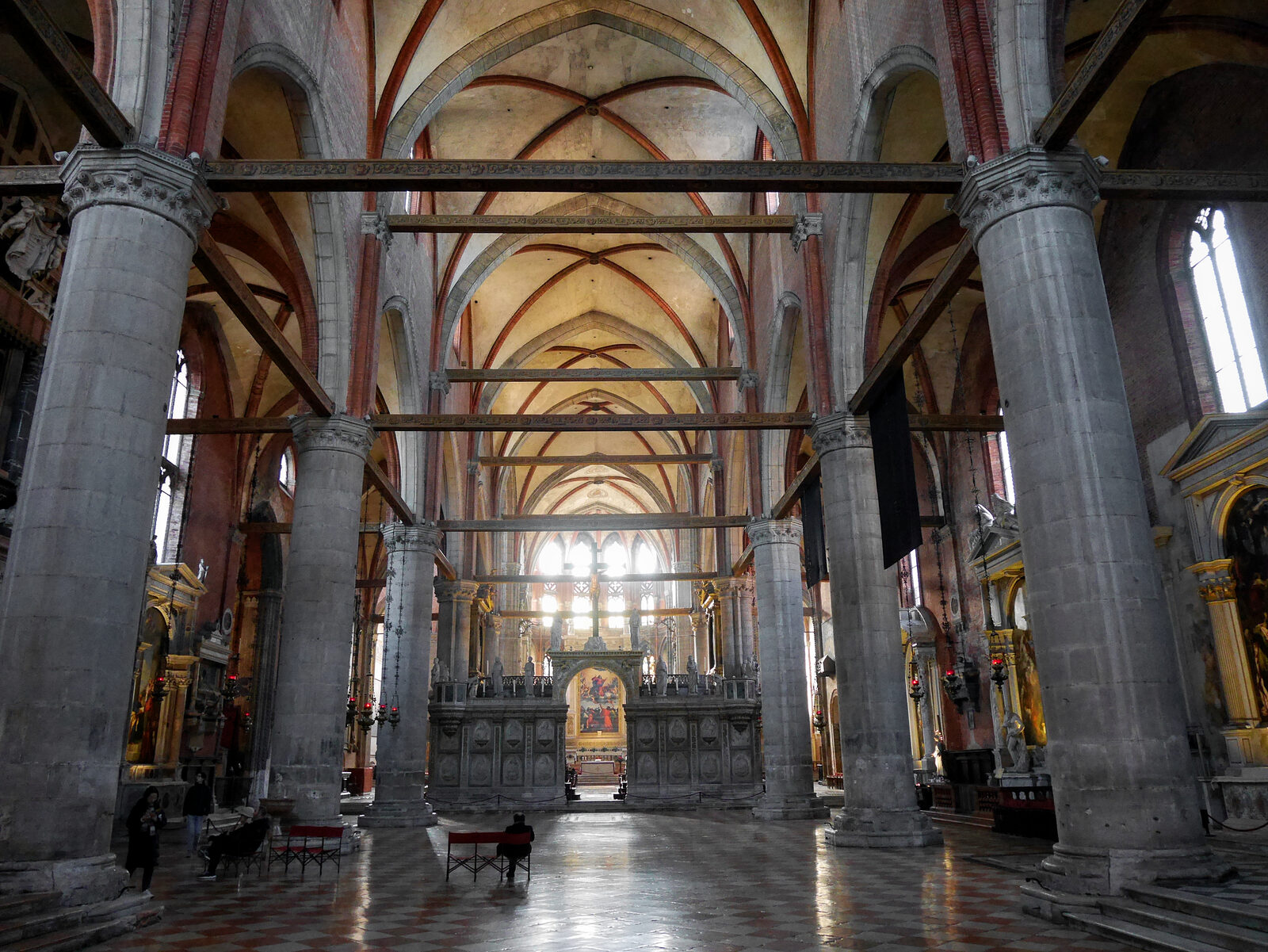 Frari Basilica : The massive nave opens up dramatically, with the high altar visible through the intricately carved choir screen