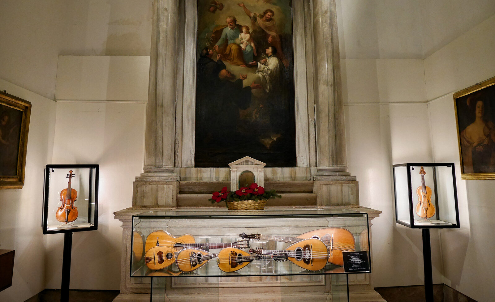Music Museum : The violins on display are flanking a depiction of San Maurizio
