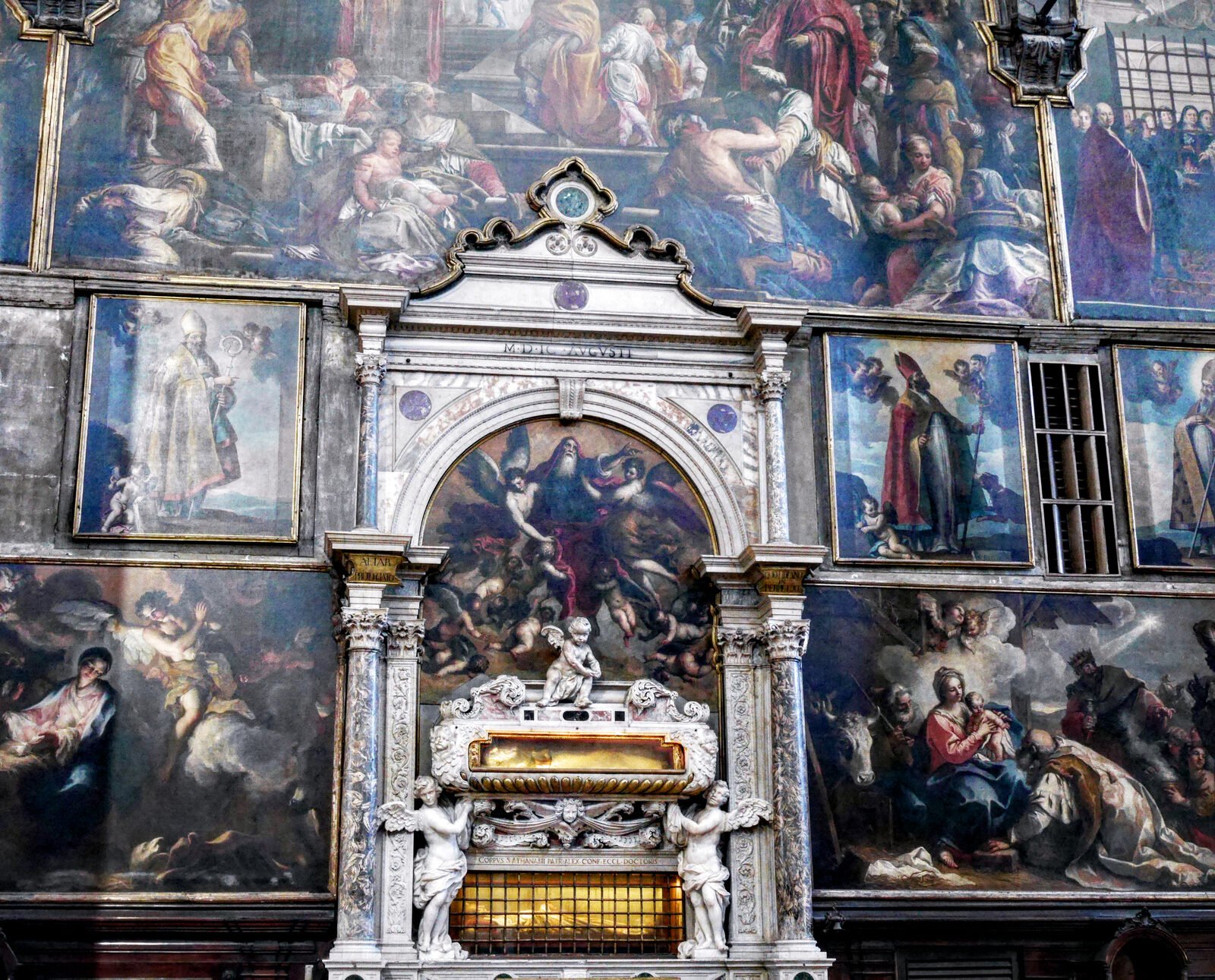 San Zaccaria : Surrounded by paintings are the wall tombs containing relics of Saint Zacharias (below) and Saint Athanasius (above)