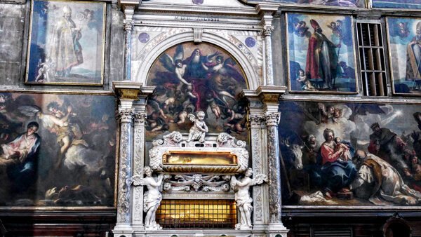 San Zaccaria : Surrounded by paintings are the wall tombs containing relics of Saint Zacharias (below) and Saint Athanasius (above)