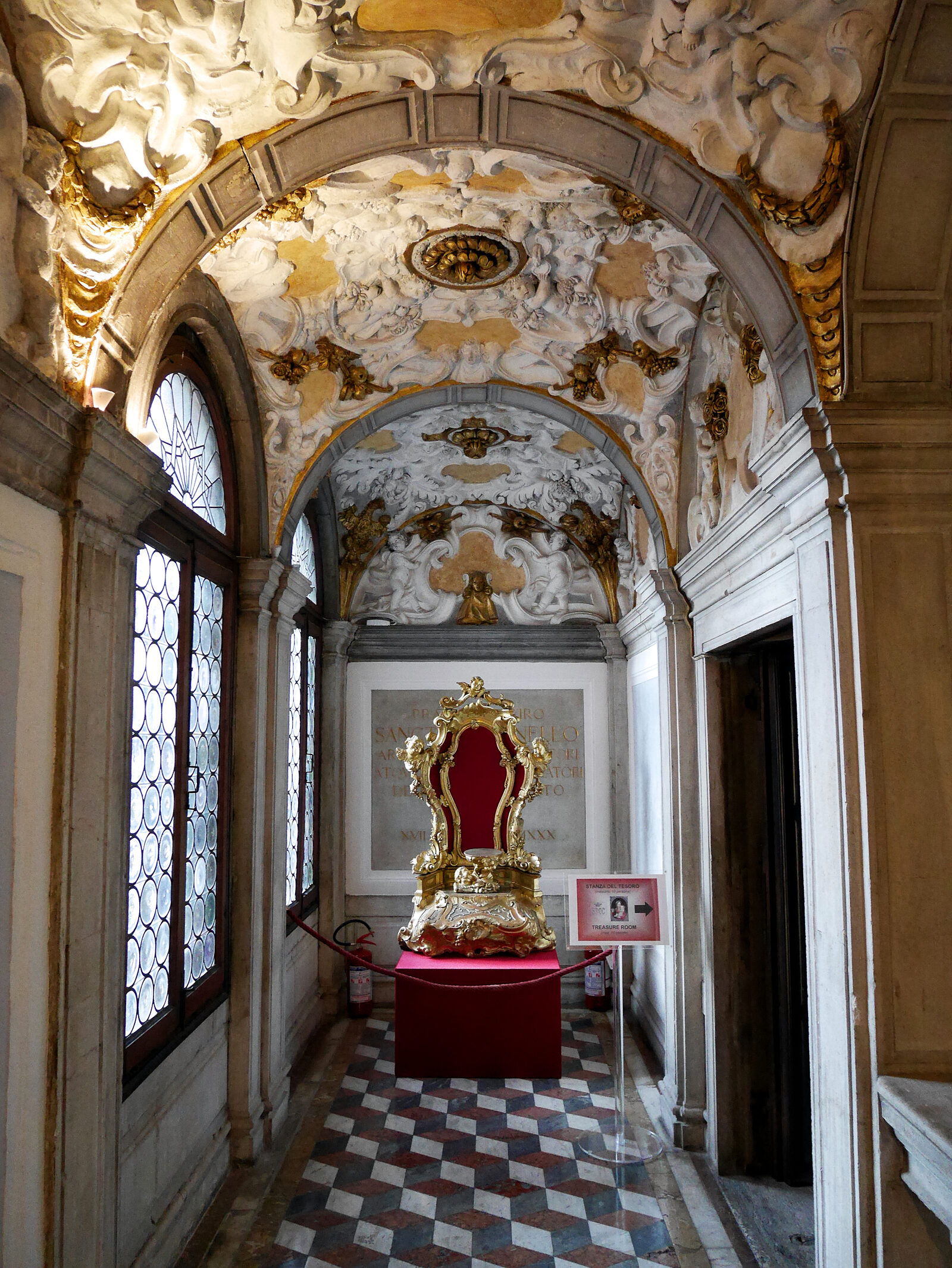 Scuola dei Carmini : The corridors leading to the staircase showcase the same intricate rococo plasterwork on their barrel-vaulted ceilings