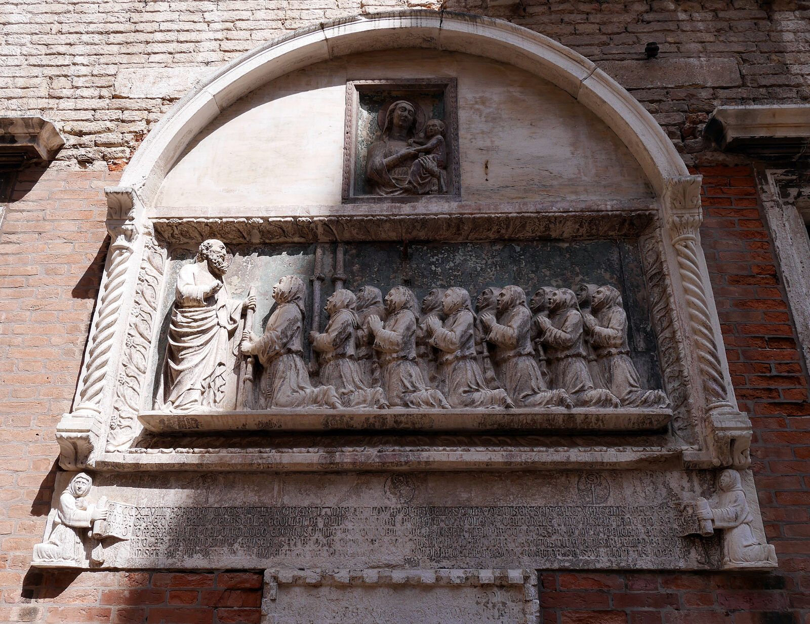 Scuola Grande San Giovanni : The bas-relief to the left of the entrance, depicting the founding brothers kneeling before St. John