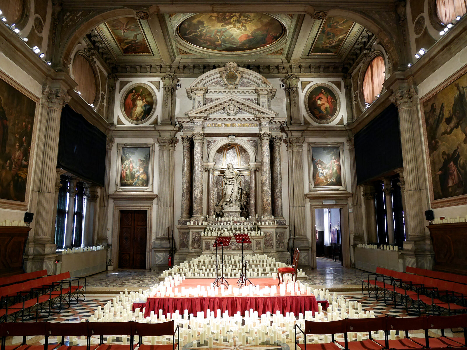 Scuola Grande San Giovanni : You can often find candles arranged in front of St. John’s statue, as the space is frequently used for candlelight concerts