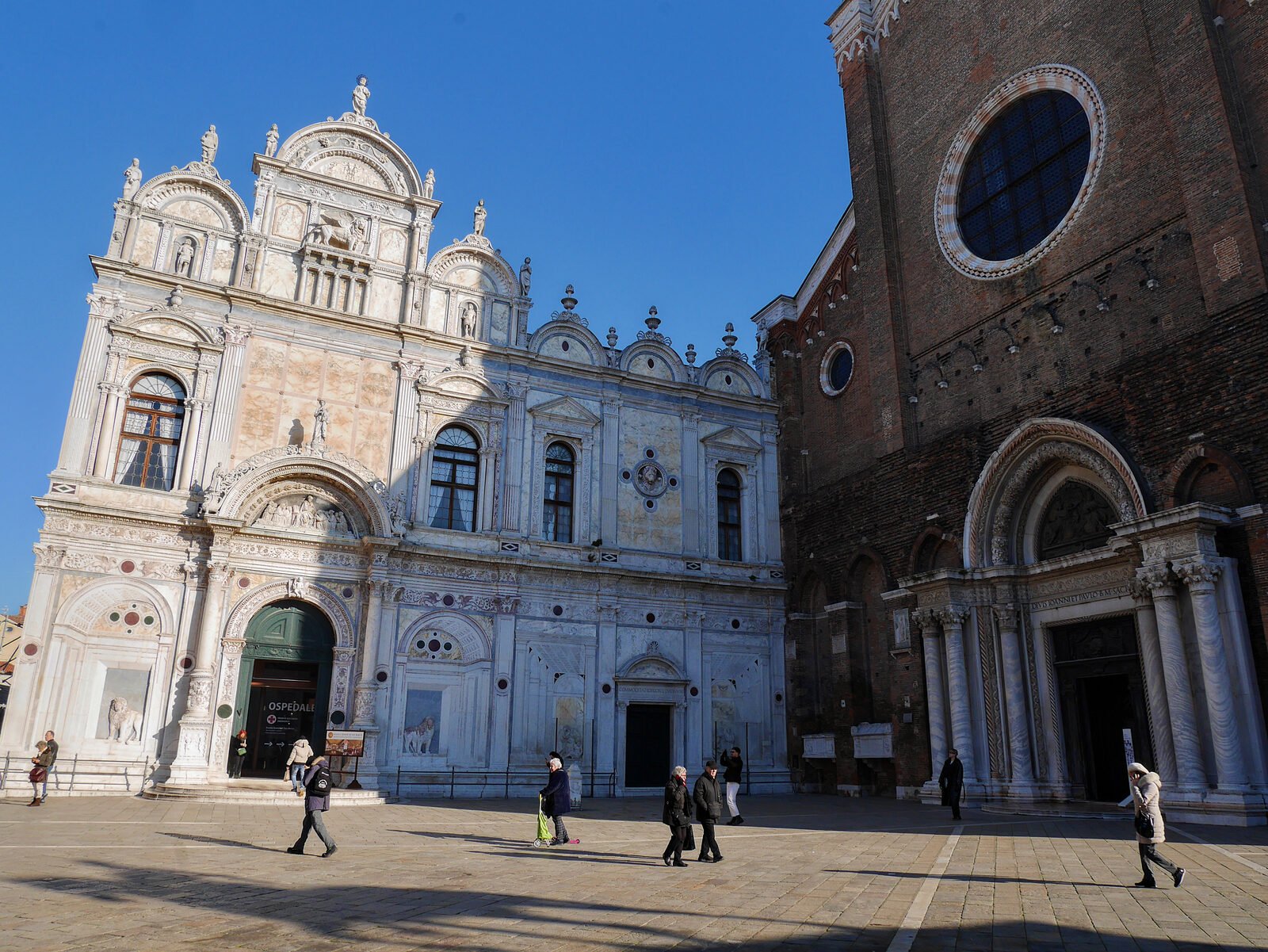 Scuola Grande San Marco : The lavish facade of the Scuola contrasts with the austere brickwork of the adjacent Santi Giovanni e Paolo