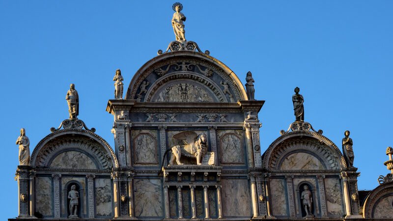 Scuola Grande San Marco : The facade features many marble statues of angels, warriors, and other fantastical creatures