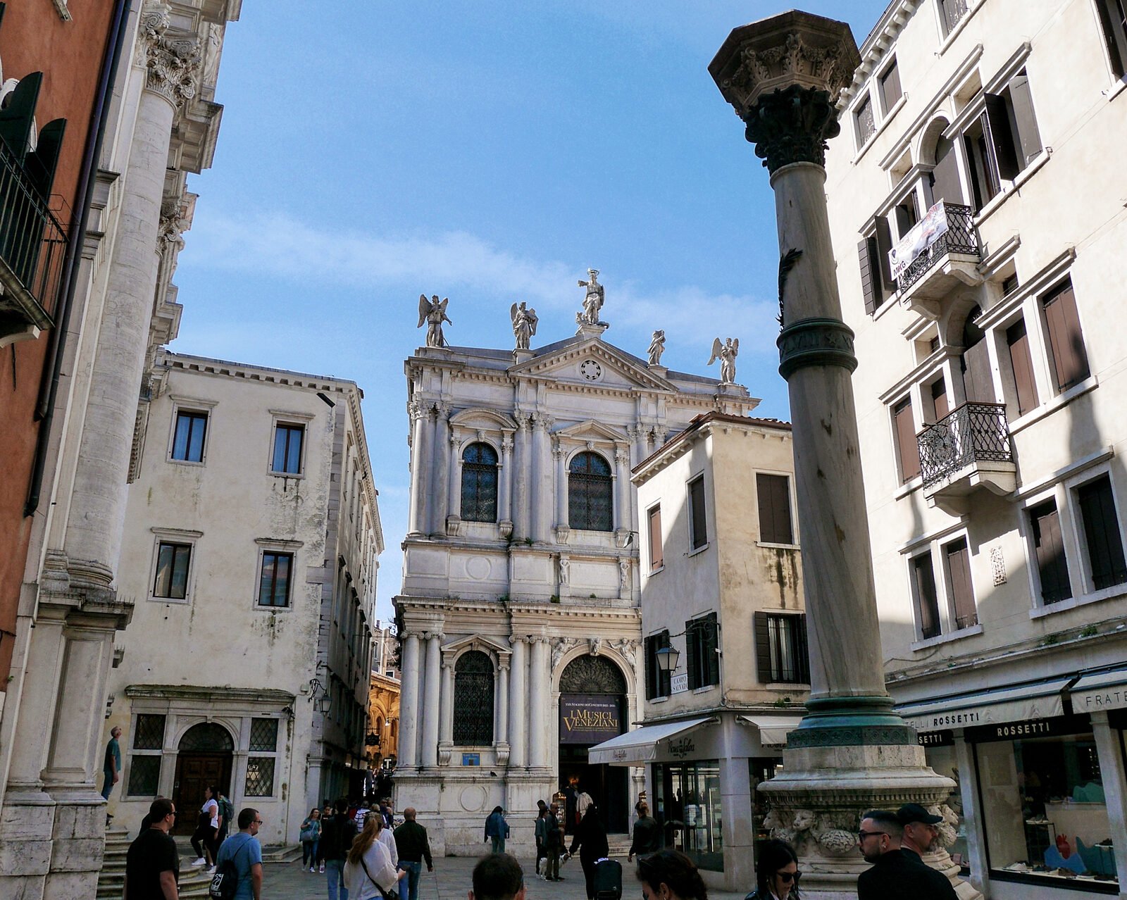 Scuola Grande San Teodoro : Stepping back a bit in the campo and the statues atop become visible: Saint Theodore in the center and adoring angels on the sides