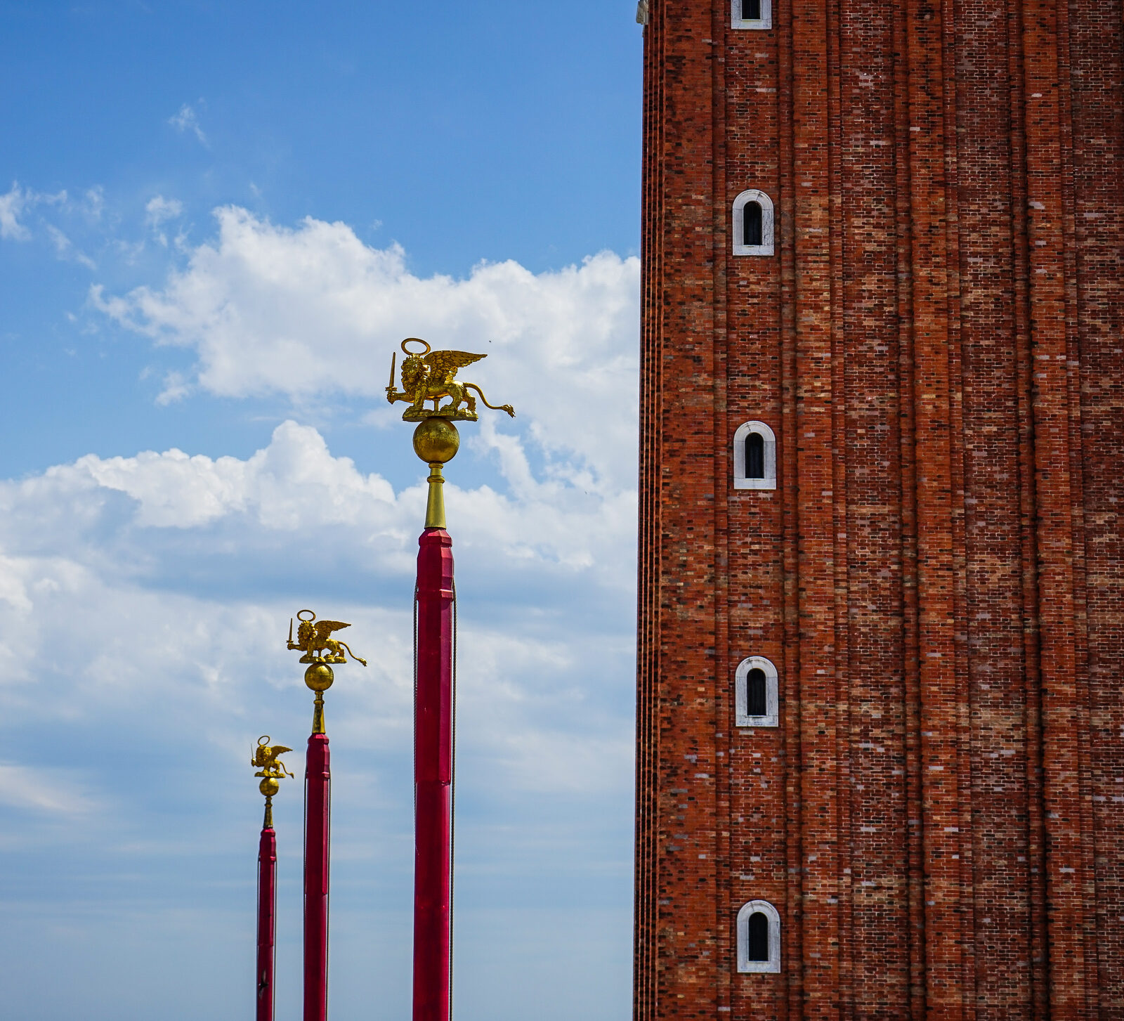 Piazza San Marco : The three red flagpoles symbolize the kingdoms conquered by Venice in its history: Cyprus, Candia, and Morea